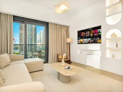 a living room with a couch and a table at UrbanStays Dubai - Act Tower in Dubai