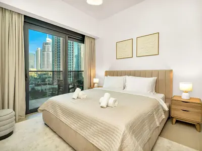a bedroom with a large bed with white towels on it at UrbanStays Dubai - Act Tower in Dubai