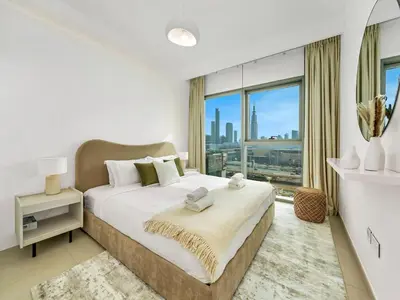 a bedroom with a large bed and a large window at UrbanStays Dubai - Downtown Views II in Dubai