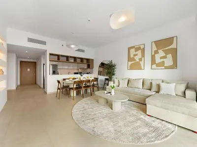 a living room with a couch and a table at UrbanStays Dubai - Downtown Views II in Dubai