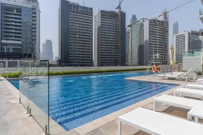 a swimming pool on the roof of a building with tall buildings at GuestReady - Charming home in Business Bay in Dubai