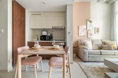 a kitchen and living room with a table and chairs at GuestReady - Charming home in Business Bay in Dubai