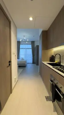 a kitchen with a hallway leading to a living room at New! Modern cosy Studio Laya Heights in Dubai