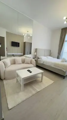 a living room with a couch and a bed at New! Modern cosy Studio Laya Heights in Dubai