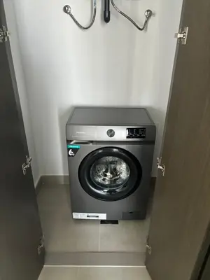 a washing machine in a bathroom with the door open at 'Dubai Creek Horizon Tower2' 1-Bedroom in Dubai