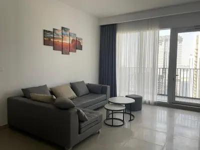 a living room with a couch and a table at 'Dubai Creek Horizon Tower2' 1-Bedroom in Dubai