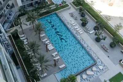 an overhead view of a large swimming pool with palm trees at Modern High-Floor Apartment with Burj Khalifa View by Dejaview Stays in Dubai