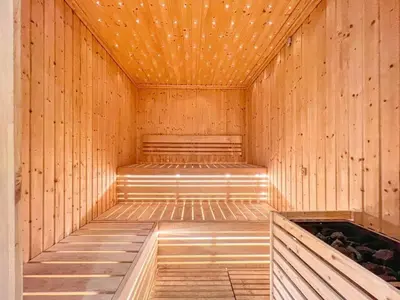a wooden sauna with a bench in the middle at Modern High-Floor Apartment with Burj Khalifa View by Dejaview Stays in Dubai