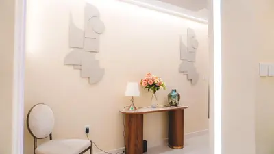 a hallway with a table with a lamp and a chair at USMANS 3 Bedroom Apartment all Rooms Sea View Direct Beach Access Daily HOUSEKEEPING JBR in Dubai