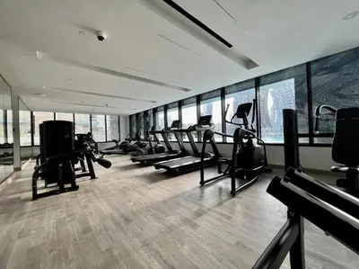 a gym with a bunch of treadmills and ellipticals at Binghatti Canal Business Bay in Dubai