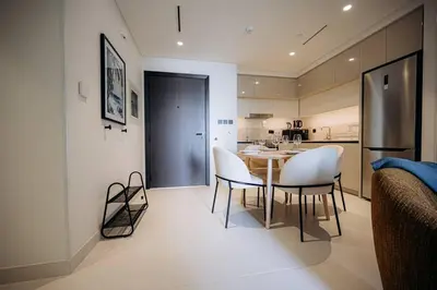 a kitchen and dining room with a table and chairs at Private Beach & Canal View-Top Location-Pool-Gym in Dubai