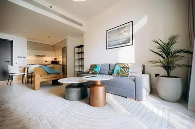 a living room with a couch and a table at Private Beach & Canal View-Top Location-Pool-Gym in Dubai