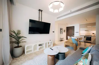 a living room with a couch and a tv at Private Beach & Canal View-Top Location-Pool-Gym in Dubai