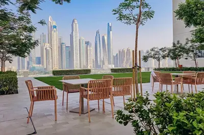 a table and chairs with a view of a city at Private Beach & Canal View-Top Location-Pool-Gym in Dubai