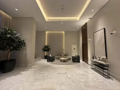 a lobby with a couch and a table in a building at Luxurious 3BR - Pool - Canal View - Kids Play Area in Dubai
