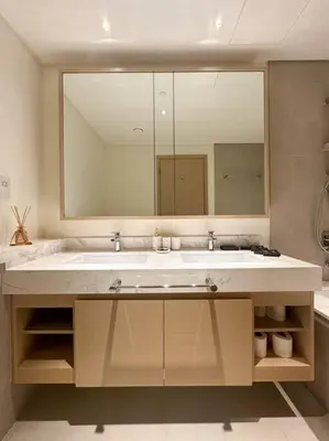 a bathroom with a sink and a large mirror at Luxurious 3BR - Pool - Canal View - Kids Play Area in Dubai