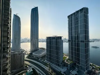 a group of tall skyscrapers in a city at Luxurious 3BR - Pool - Canal View - Kids Play Area in Dubai
