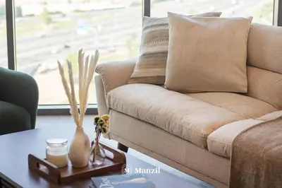 a living room with a couch and a table at Manzil - 1BR Apartment in Farhad Aziz Residence with Burj View in Dubai