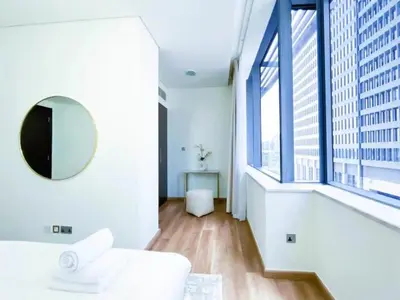 a white room with a mirror and a large window at Stunning 2 bedrooms in Sky Gardens DIFC in Dubai