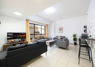 a living room with two couches and a tv at 2 min walk to JBR Beach & Dubai Marina - Sea View in Dubai