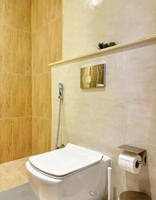 a bathroom with a white toilet in a room at Cozy Studio JVC Dubai, Short Drive to Dubai Marina, JBR, Downtown Dubai in Dubai