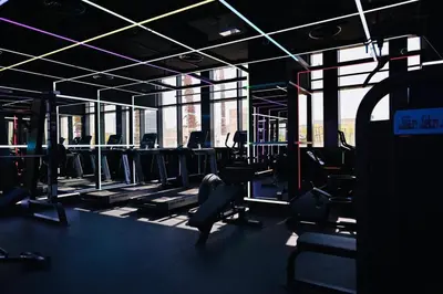 a gym with a lot of chairs and windows at Cozy Studio JVC Dubai, Short Drive to Dubai Marina, JBR, Downtown Dubai in Dubai