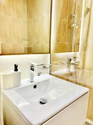 a bathroom with a white sink and a mirror at Cozy Studio JVC Dubai, Short Drive to Dubai Marina, JBR, Downtown Dubai in Dubai