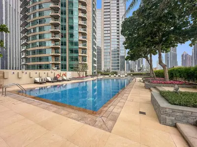 a swimming pool in a city with tall buildings at FIRST CLASS 1BR Modern Downtown Oasis in Dubai