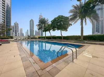 a swimming pool in the middle of a city at FIRST CLASS 1BR Modern Downtown Oasis in Dubai