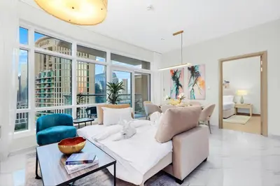 a living room with a couch and a table at FIRST CLASS 1BR Modern Downtown Oasis in Dubai