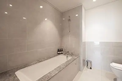a bathroom with a bath tub and a toilet at 2Bed-400m from Burj Khalifa- Heart of Dubai in Dubai