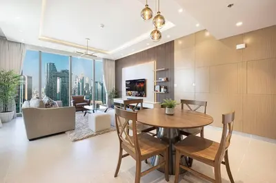 a dining room with a table and a living room at 2Bed-400m from Burj Khalifa- Heart of Dubai in Dubai