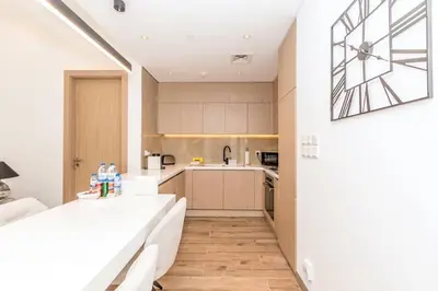 a kitchen with a table and a counter top at Luxury Apartment in Oakley Square Residences, JVC in Dubai