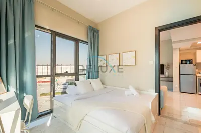 a bedroom with a white bed and a large window at Charming 2BR at MAG 515 Dubai South by Deluxe Holiday Homes in Dubai