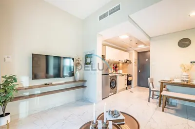 a living room with a table and a tv at Charming 2BR at MAG 515 Dubai South by Deluxe Holiday Homes in Dubai
