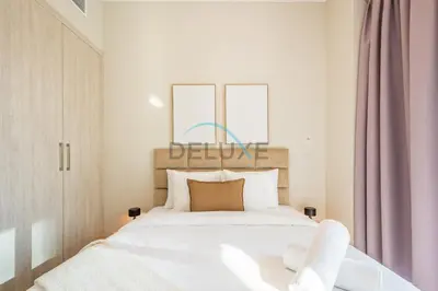 a bedroom with a white bed and two windows at Charming 2BR at MAG 515 Dubai South by Deluxe Holiday Homes in Dubai