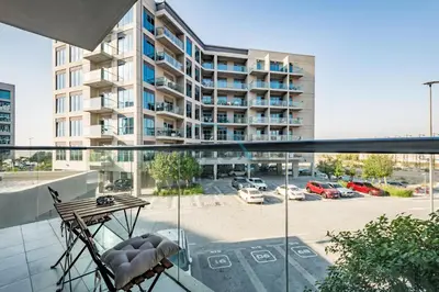 an apartment balcony with a view of a parking lot at Charming 2BR at MAG 515 Dubai South by Deluxe Holiday Homes in Dubai
