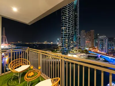 a balcony with a view of the city at night at Brand New! Dubai Eye & JBR Beach Panorama! in Dubai