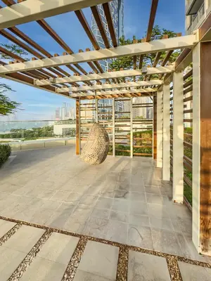 a pergola with a bench on a patio at Brand New! Dubai Eye & JBR Beach Panorama! in Dubai