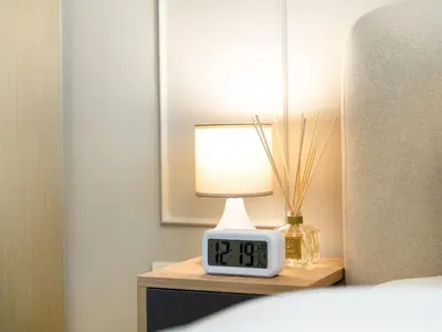 a clock on a table with a lamp on it at Brand New! Dubai Eye & JBR Beach Panorama! in Dubai