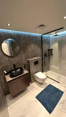 a bathroom with a toilet and a sink and a shower at Lavender 2 jvc in Dubai