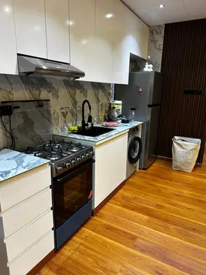 a kitchen with a stove and a sink at Lavender 2 jvc in Dubai