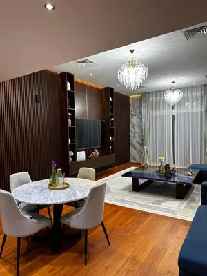 a living room with a dining table and chairs at Lavender 2 jvc in Dubai