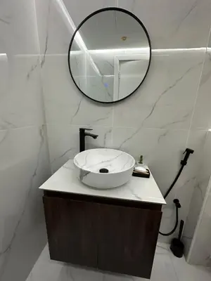 a bathroom with a sink and a mirror on a counter at Lavender 2 jvc in Dubai