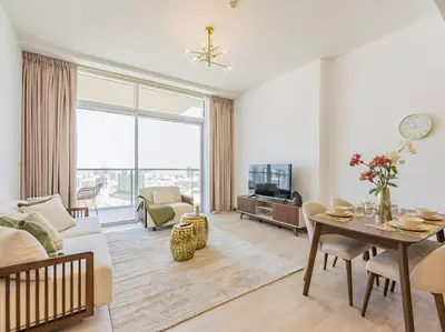 a living room with a couch and a table at Elegant One Bed Apartment - Hameni Tower,JVC in Dubai