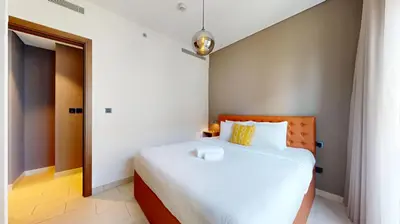 a bedroom with a large white bed in a room at Locations I Creek Vistas Reserve I Luxury Calm 1BR I 12 Min Drive to Downtown Dubai & Business Bay I Modern Comfort in Meydan Community in Dubai