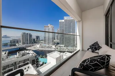 a living room with a view of the city at Vida Creek Beach 1 Bedroom in Dubai