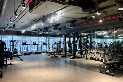a gym with lots of treadmills and machines at Studio Sterling BusinessBay in Dubai