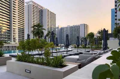 a hotel patio with couches and umbrellas at Studio Sterling BusinessBay in Dubai