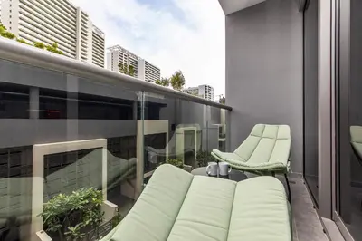 a balcony with a couch and chairs on a building at Studio Sterling BusinessBay in Dubai